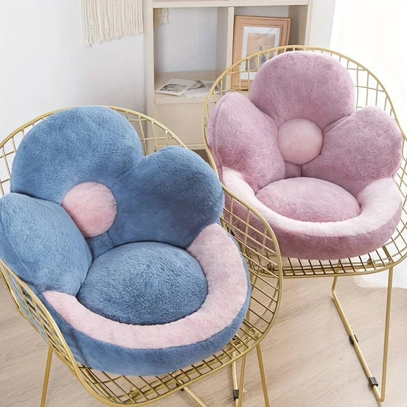 Two floral-shaped kawaii cushions, one blue and one pink, on gold wire chairs.