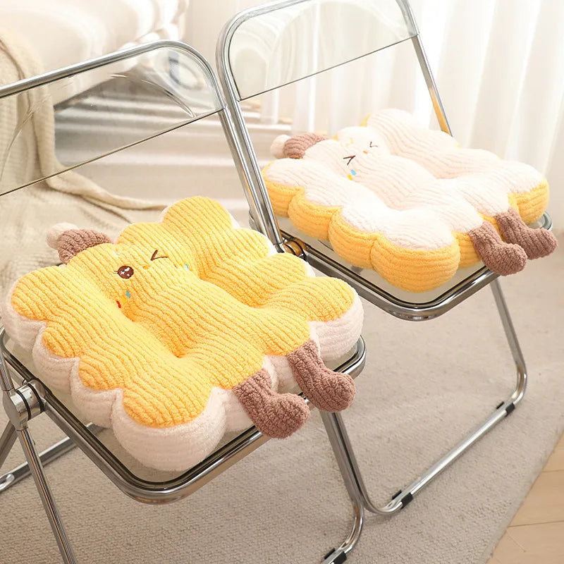 Yellow and white plush kawaii cushion with brown accents on a metal chair.