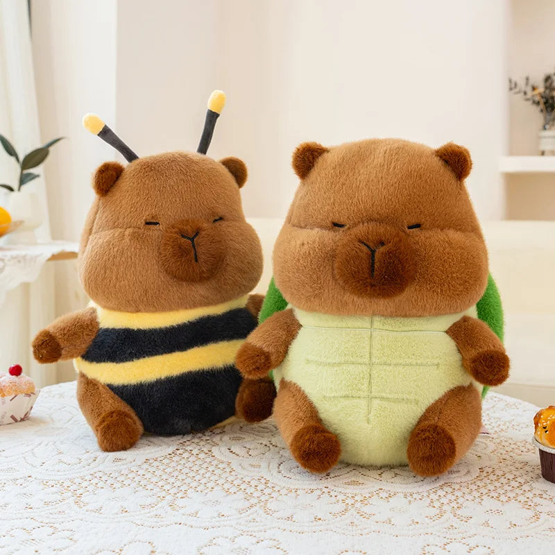 Two kawaii plush toys, one resembling a bee and the other a bear, on a lace tablecloth.