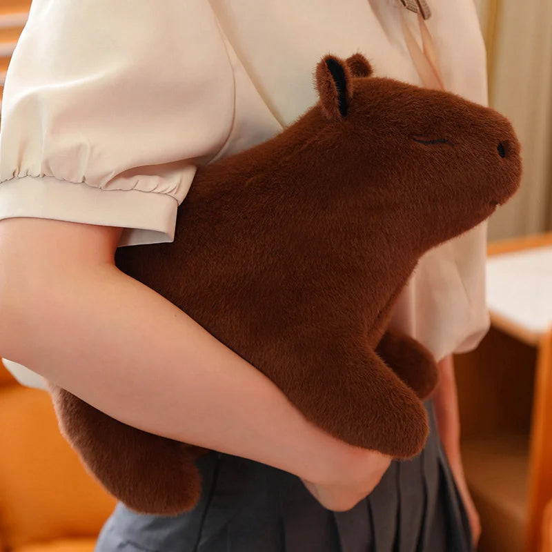 Person holding a brown kawaii plush toy resembling a beaver.
