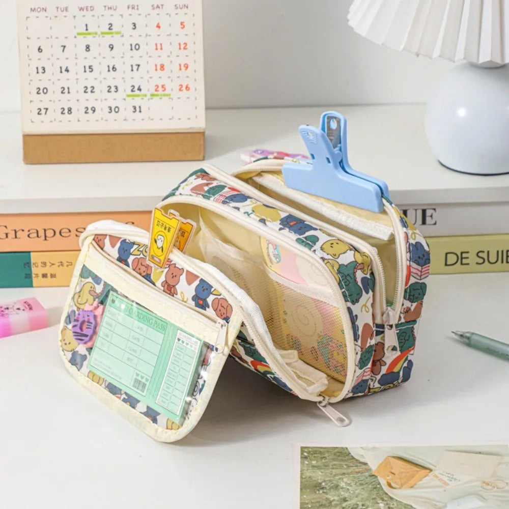 Colorful pencil case with kawaii cartoon design on a desk with books and a calendar in the background.