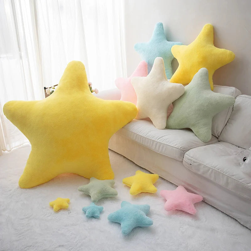 Colorful star-shaped kawaii cushions on a sofa and floor.