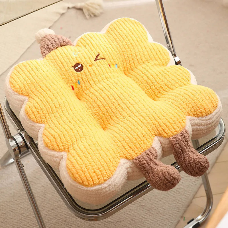 Yellow plush kawaii cushion shaped like a cartoon character on a chair.