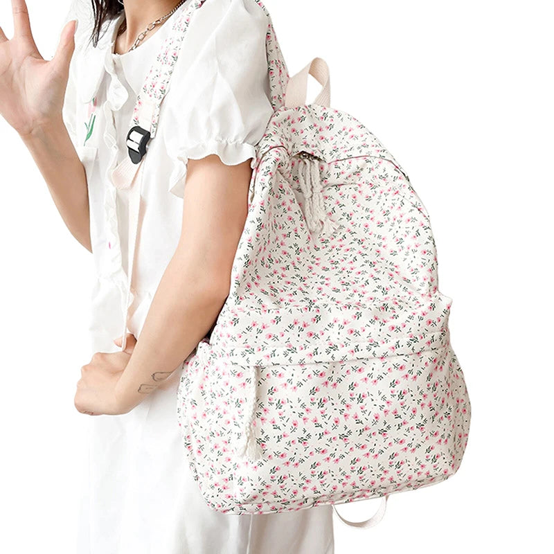Person holding a Kawaii floral drawstring bag on a white background