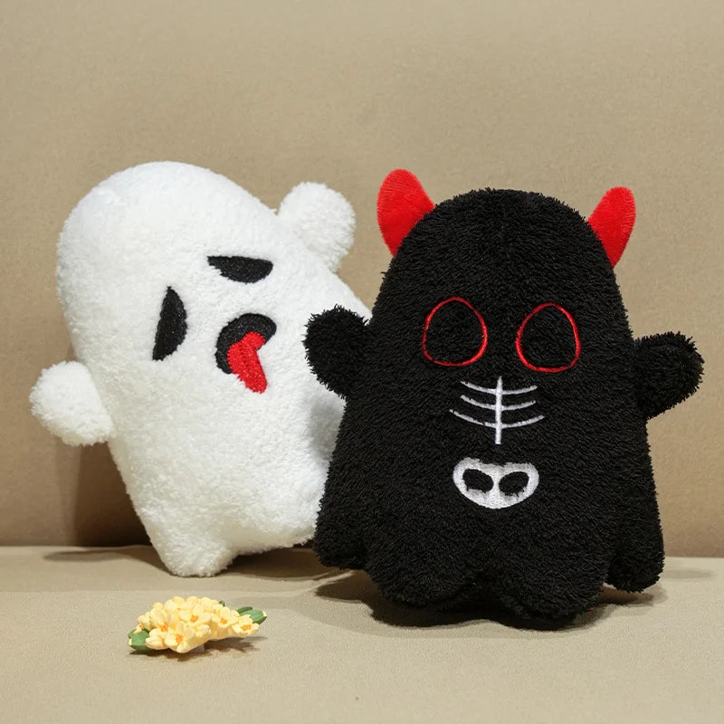White ghost plush kawaii toy and black cat plush toy with red accents on a beige background