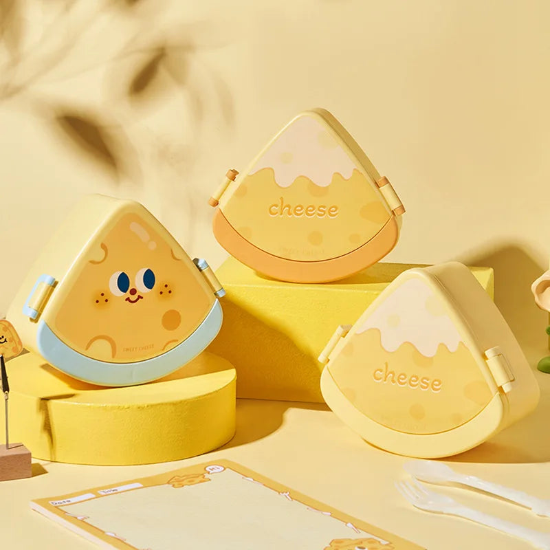 Yellow kawaii cheese-shaped bento boxes with cartoon face on a yellow background
