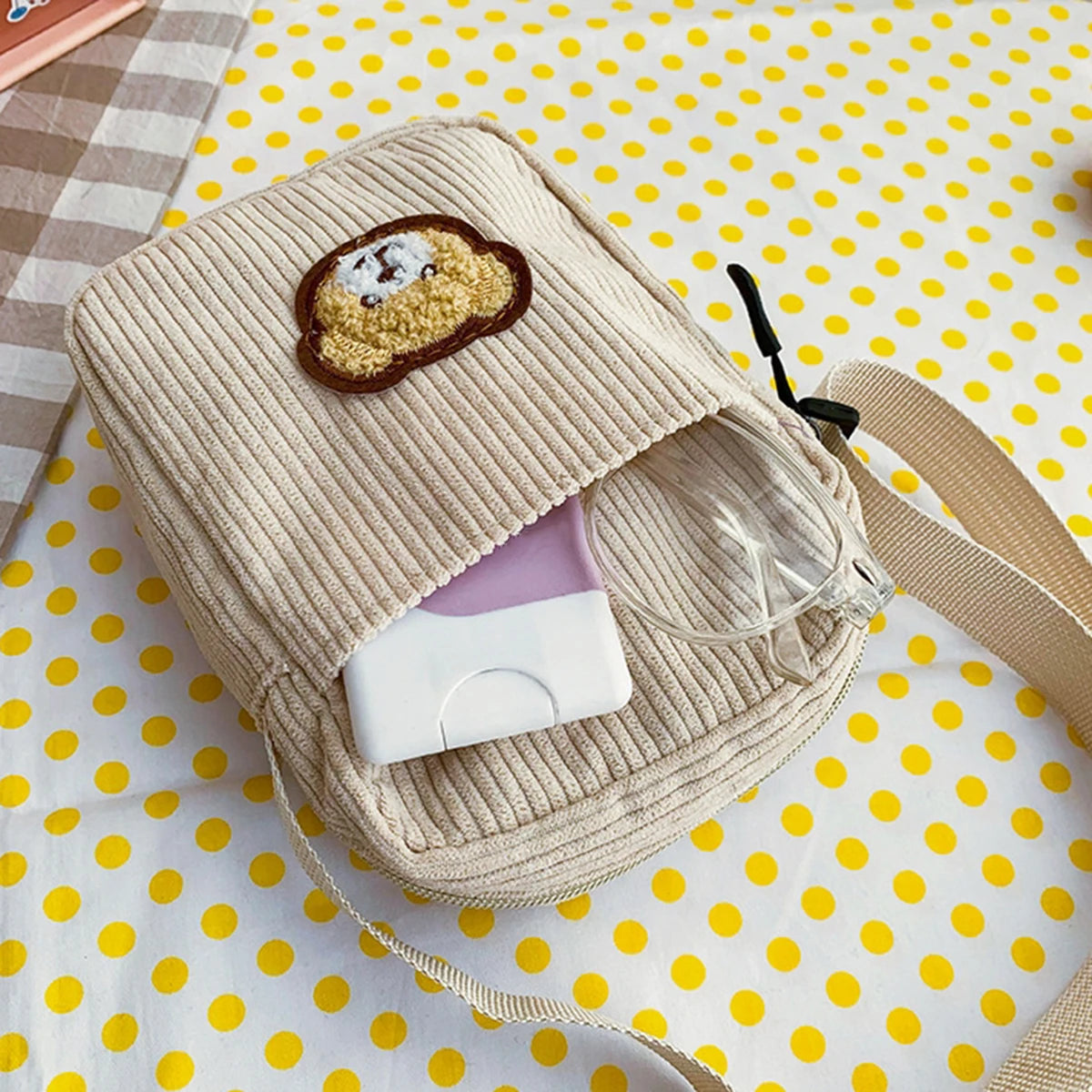Beige corduroy pouch with Kawaii cartoon bear design on a yellow polka dot background
