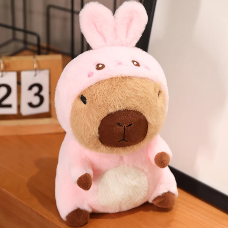 Kawaii plush toy with a rabbit costume on a wooden surface