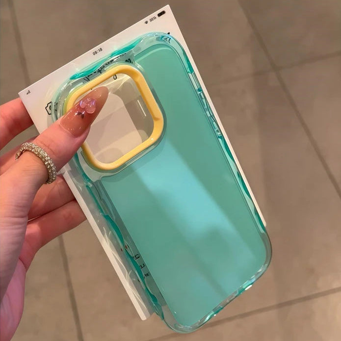 Hand holding a turquoise kawaii phone case with a yellow handle against a neutral background