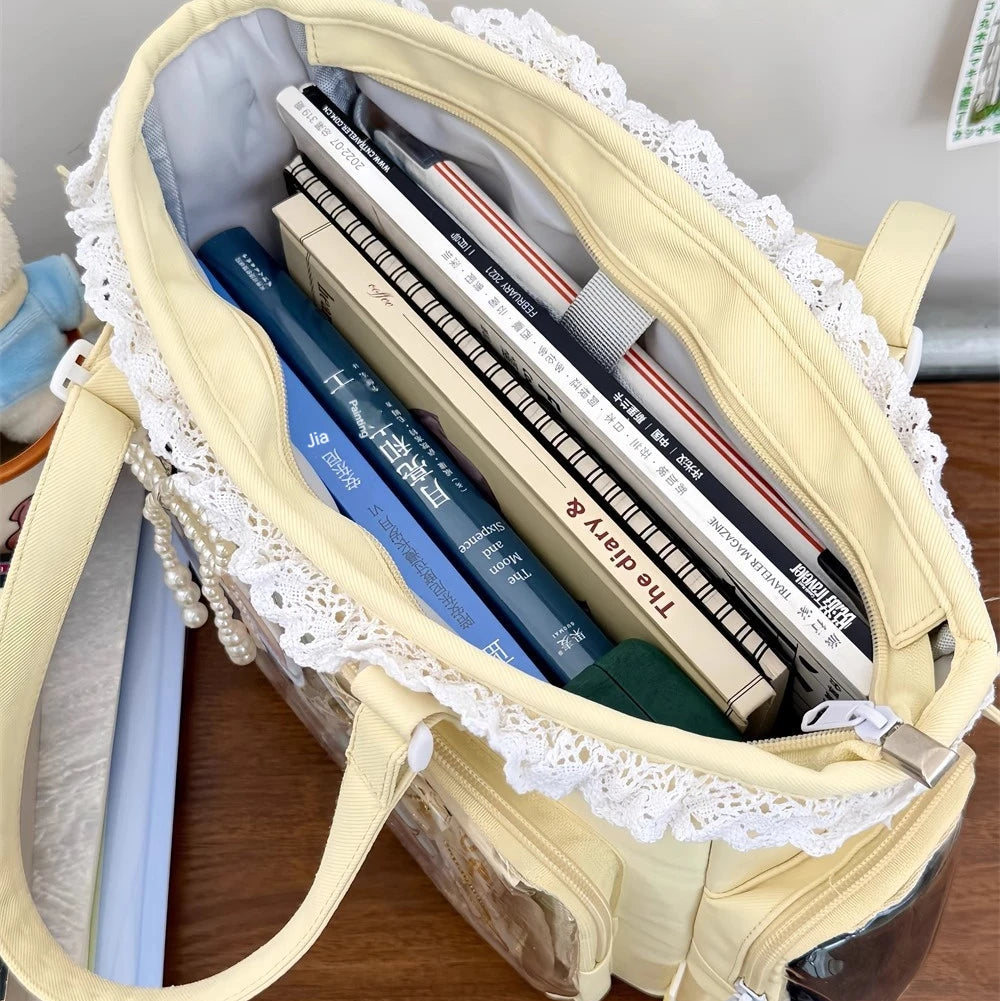 Beige Kawaii tote bag with lace details filled with books on a wooden surface.