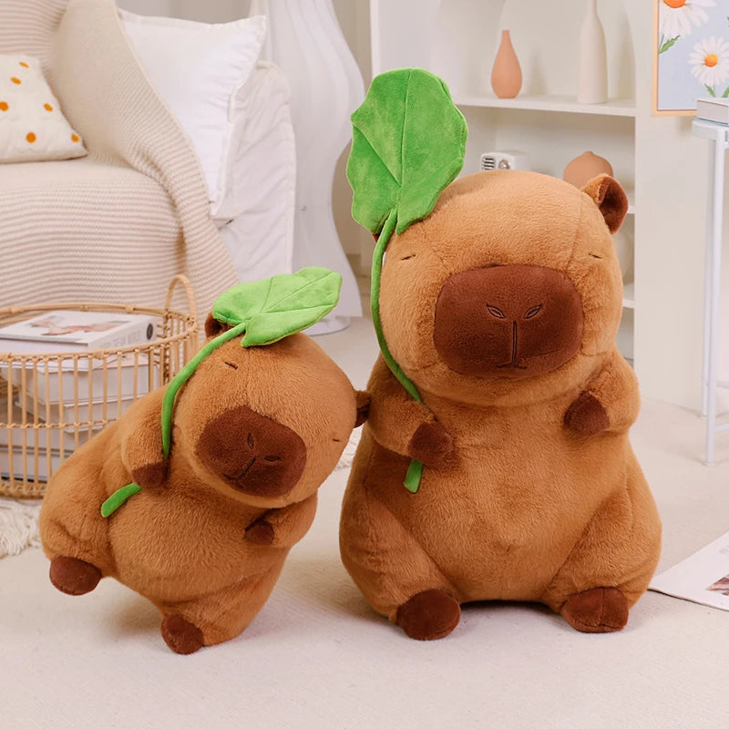 Two brown kawaii plush toys with green leaves on a light-colored surface.