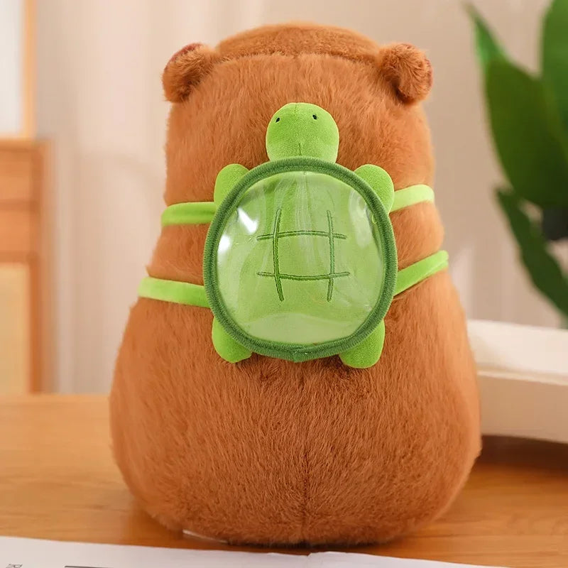 Brown kawaii plush toy with a green turtle design on a wooden surface