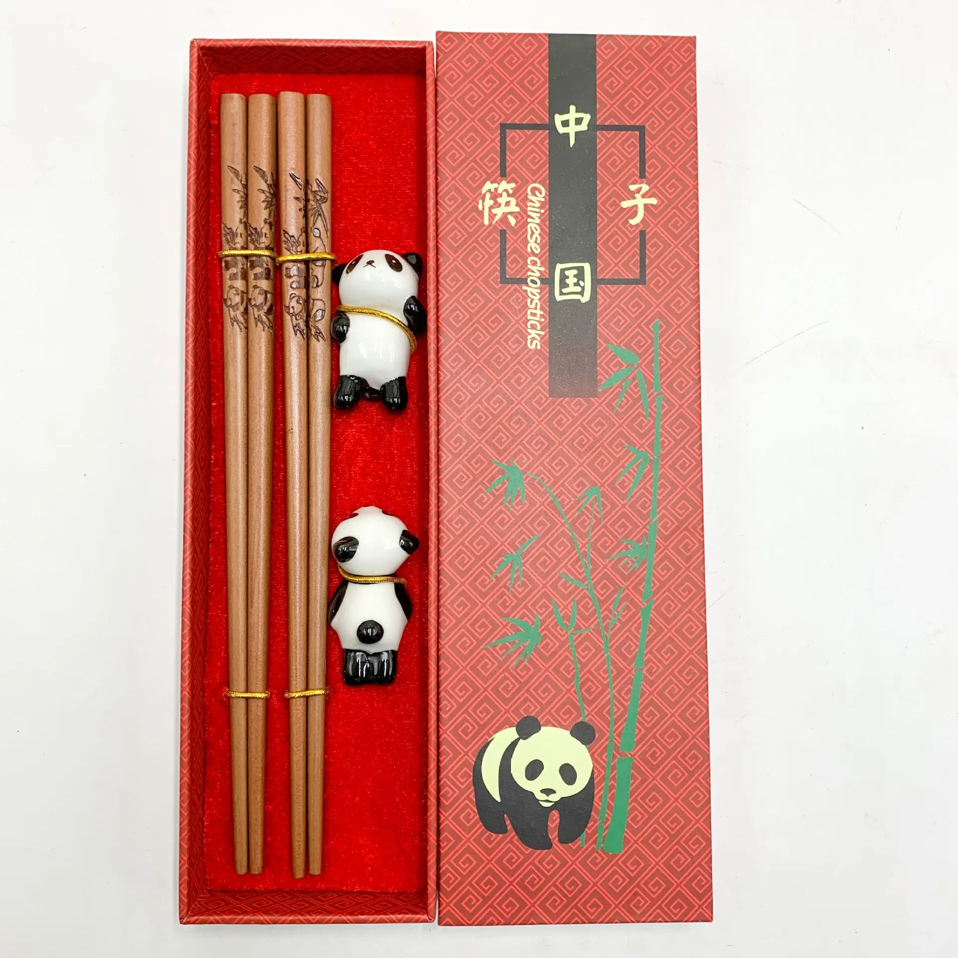 Chopsticks set with kawaii panda decorations in a red box on a white background