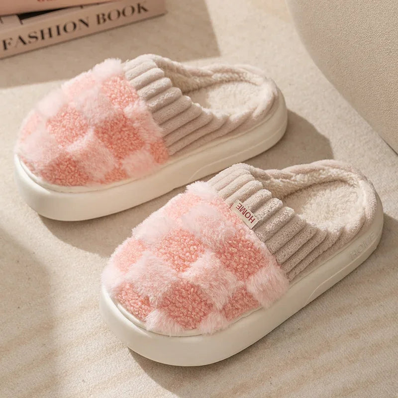 Pair of pink and gray kawaii checkered slippers on a beige surface with a fashion book in the background.
