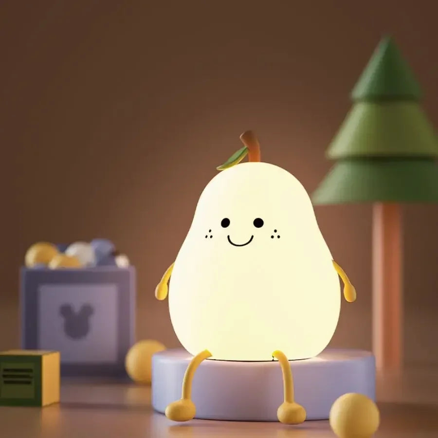 Cute pear-shaped kawaii night light with a smiling face on a wooden surface.