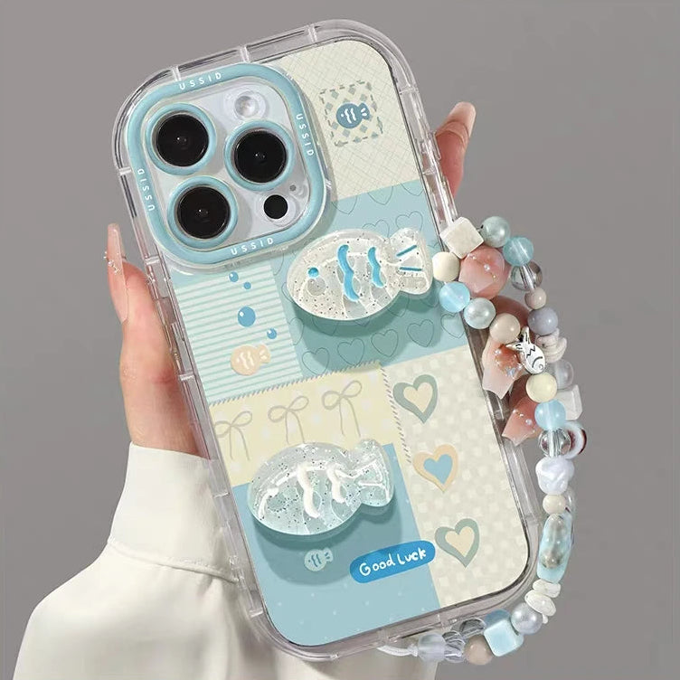 Phone case with kawaii decorative elements and a beaded strap on a gray background