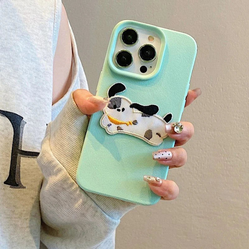 Phone case with a kawaii dog design held by a person against a neutral background