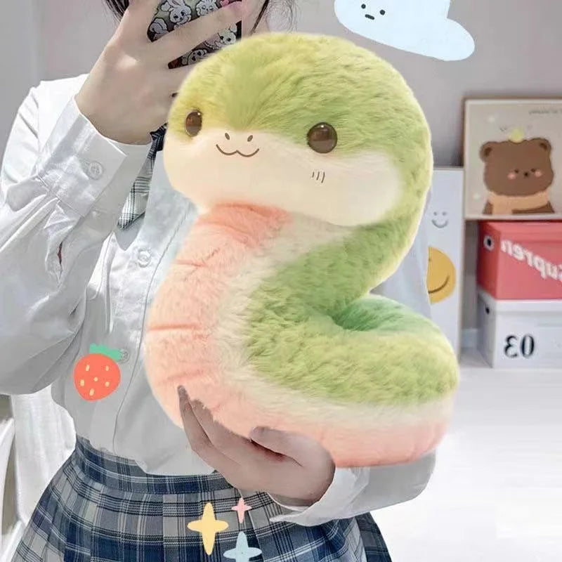 Person holding a plush kawaii toy shaped like the number '2' with a gradient of green to pink.
