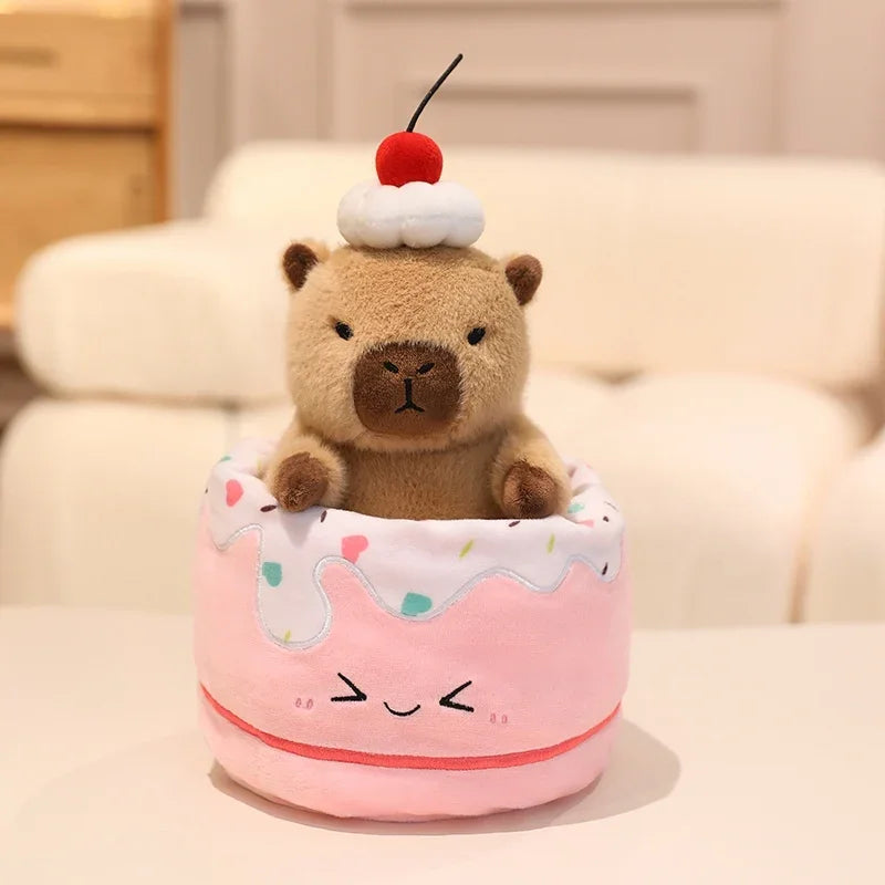 Kawaii plush toy bear in a pink ice cream cone container with a cherry on top, sitting on a light-colored surface.