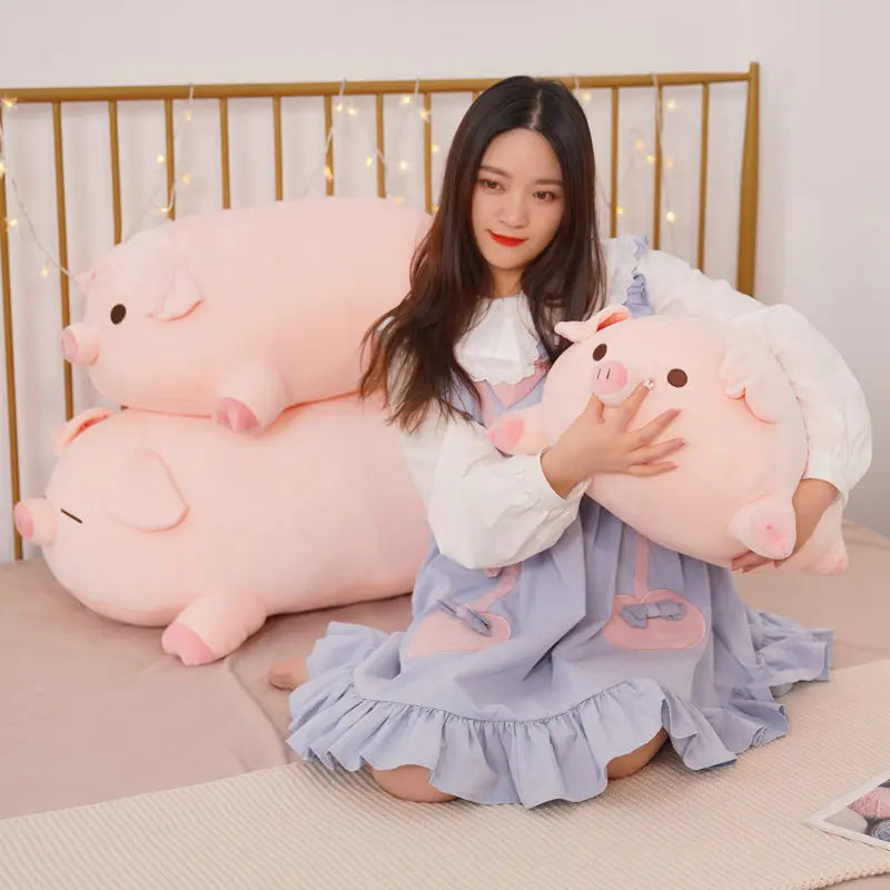 Woman holding a large pink pig kawaii plush toy in a bedroom setting