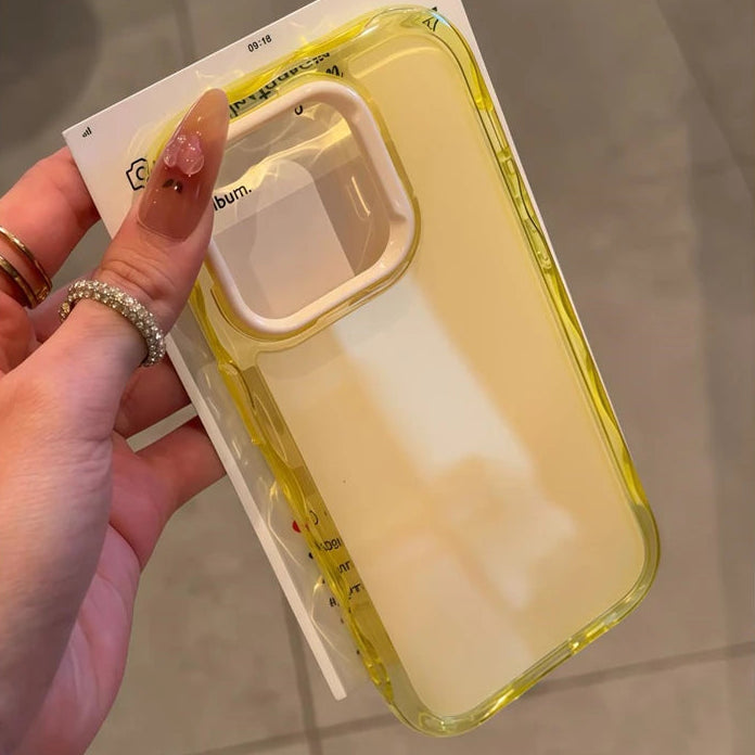 Hand holding a yellow kawaii phone case with a clear back