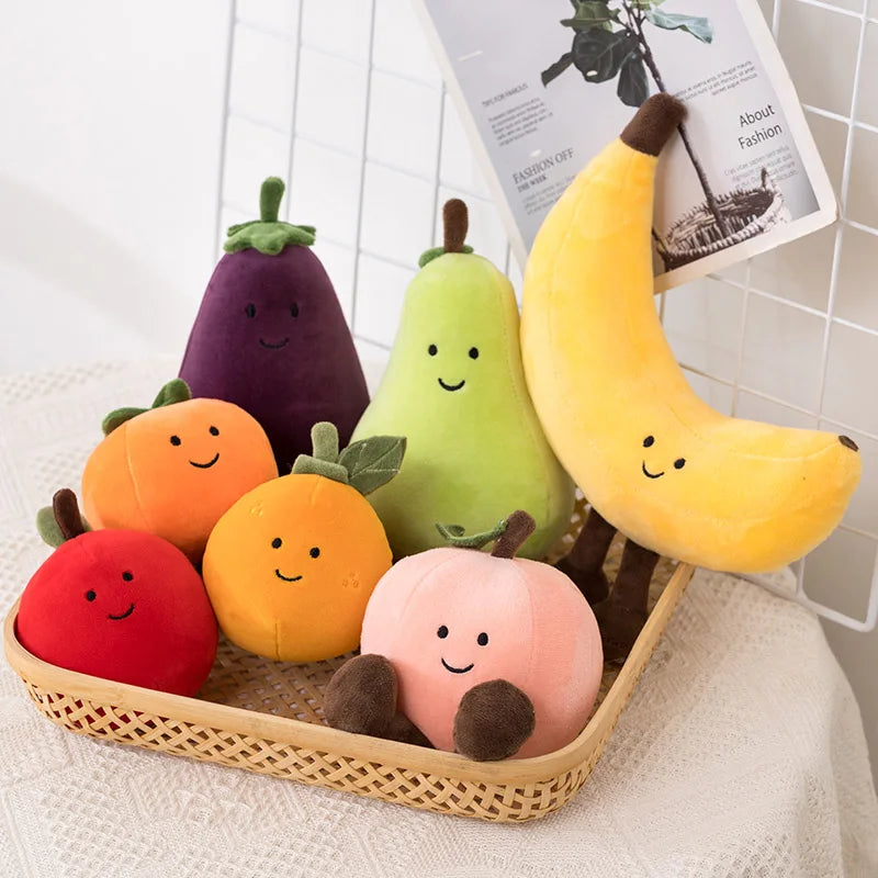 Set of plush kawaii toy fruits and vegetables in a basket on a white surface.