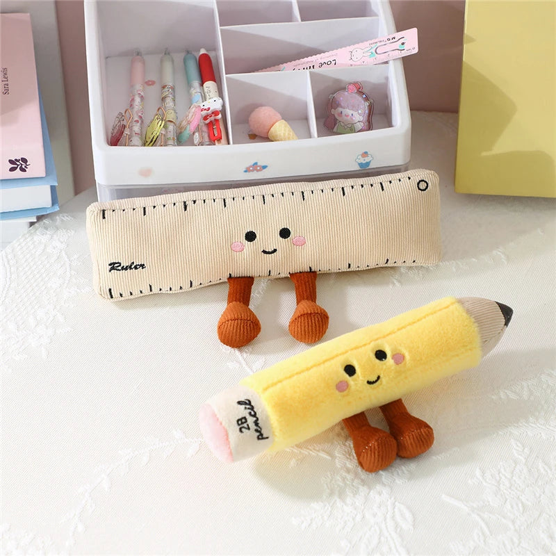 Kawaii plush ruler and pencil with cartoon faces on a white surface