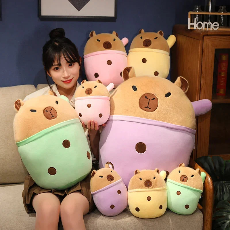 Woman holding a collection of colorful hamster-shaped kawaii plush toys in a living room setting.