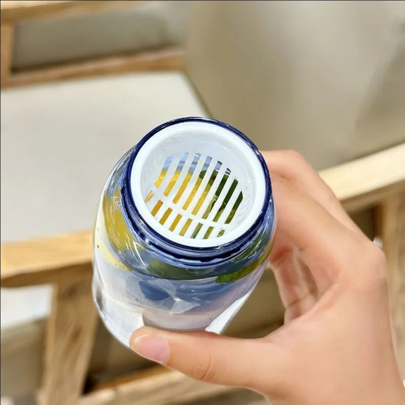 Hand holding a clear container with a blue lid, showing a gradient color Kawaii pattern inside.
