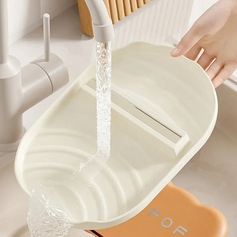 White kawaii-style colander with water flowing over it in a kitchen setting