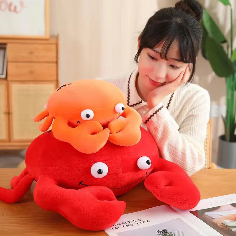 Person sitting with a large kawaii plush crab toy on a table