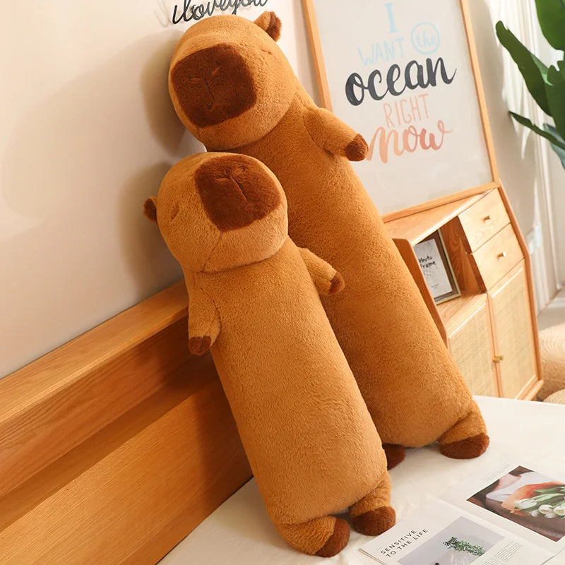 Two brown kawaii plush toys resembling dogs on a wooden surface with a decorative frame in the background.