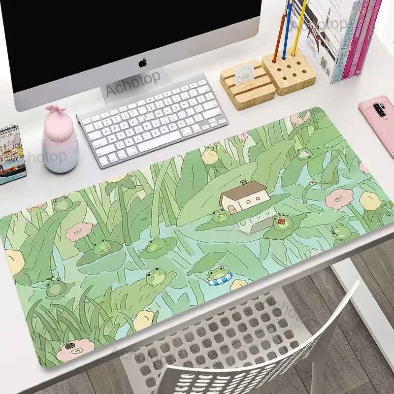 Desk setup with a Kawaii frog-themed mouse pad, keyboard, and office items.