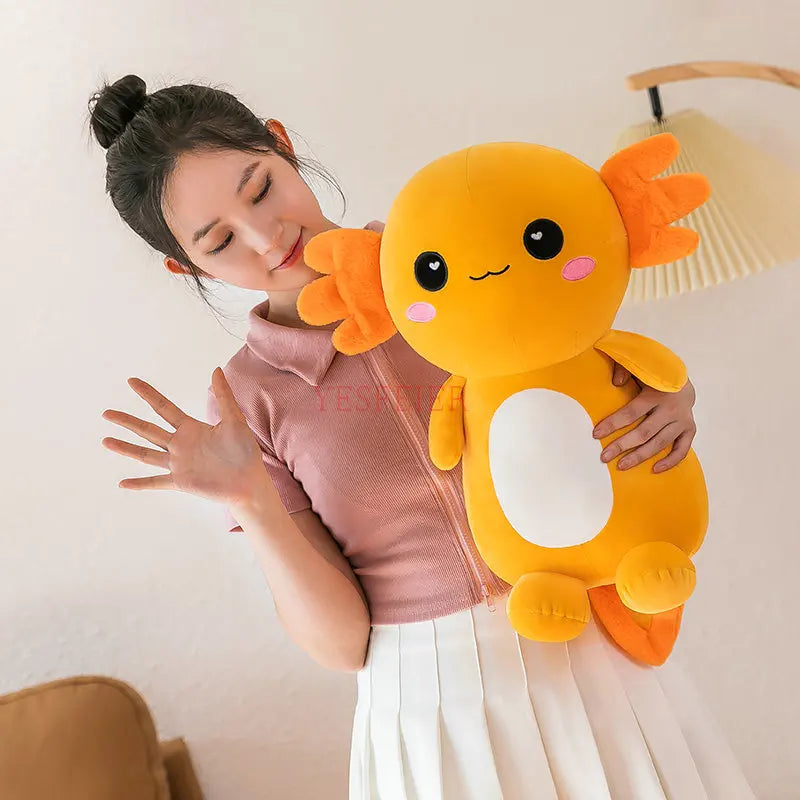 Woman holding a large, plush axolotl kawaii toy against a neutral background