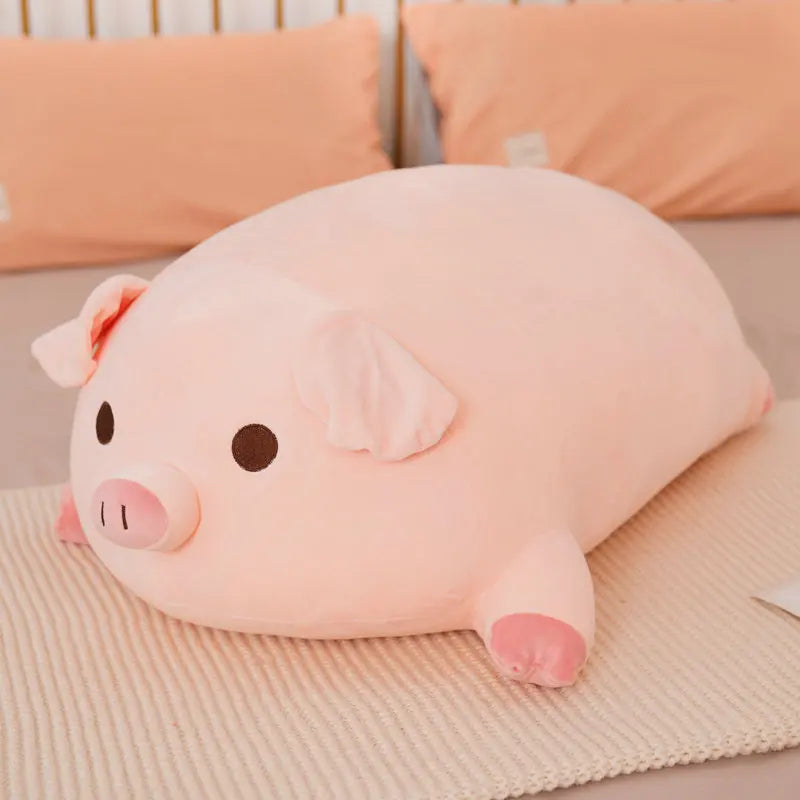 Plush pig pillow on a bed with pink kawaii pillows in the background