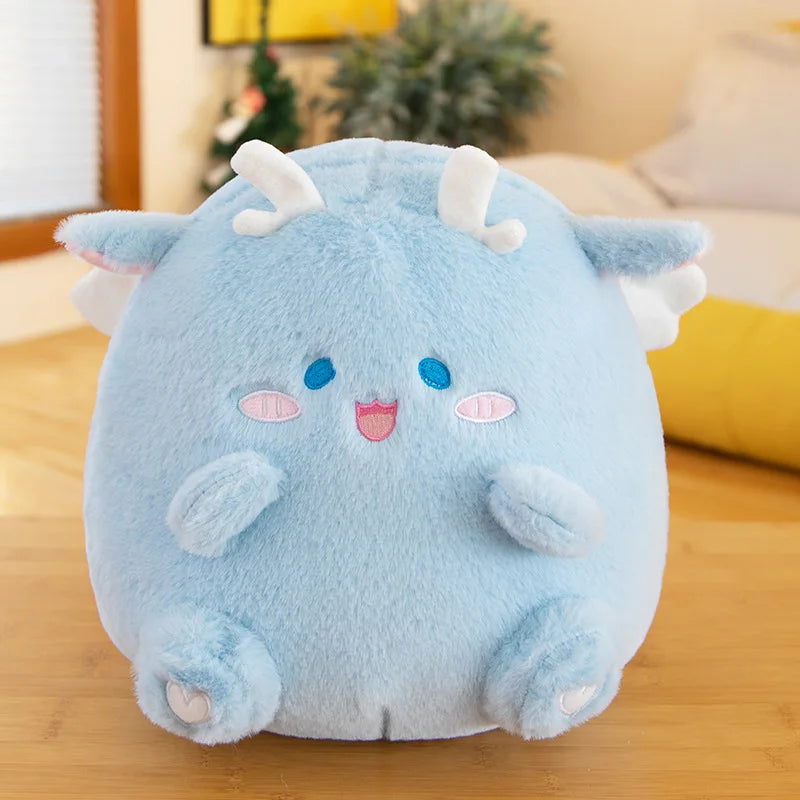 Blue kawaii plush toy with white horns on a wooden surface