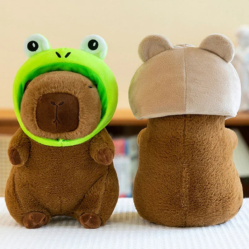 Two kawaii plush toys, one resembling a bear with a green helmet and the other a mushroom, on a light-colored surface.