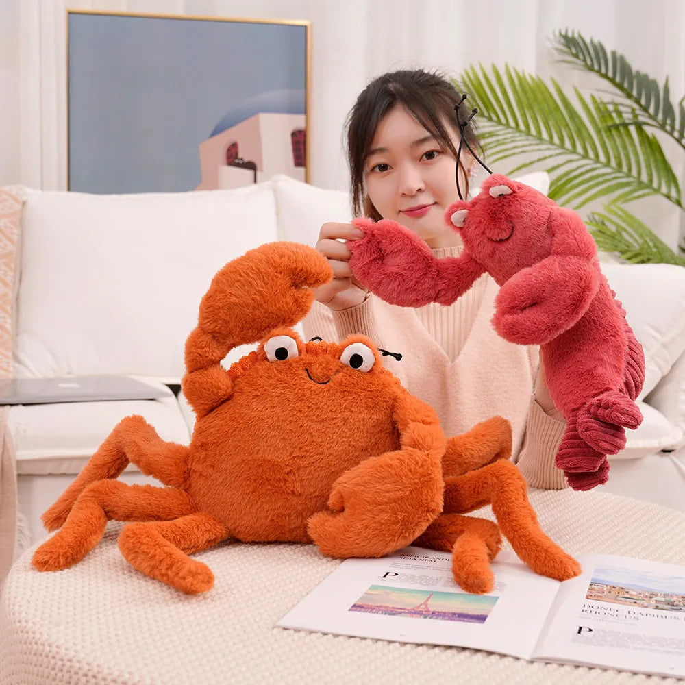 Person holding two kawaii plush toys, an orange crab and a red lobster, on a couch.