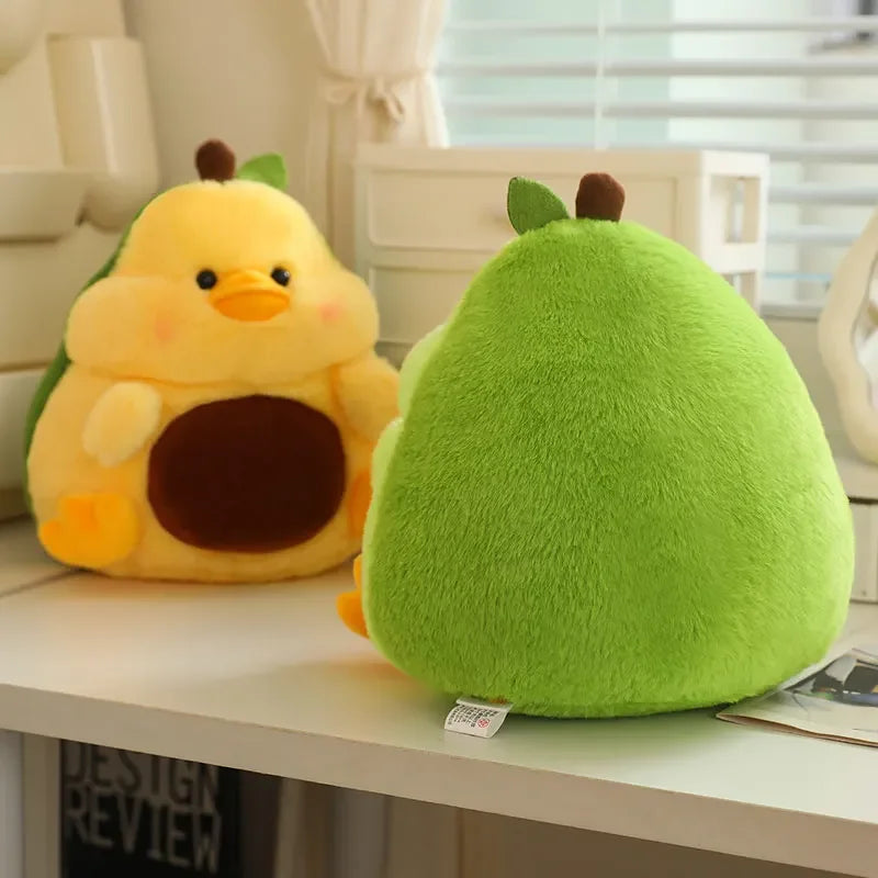 Two kawaii plush toys, one yellow and one green, resembling animals on a white surface.