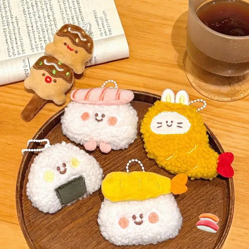 Set of cute kawaii plush keychains on a wooden tray with a cup of tea and newspaper in the background.