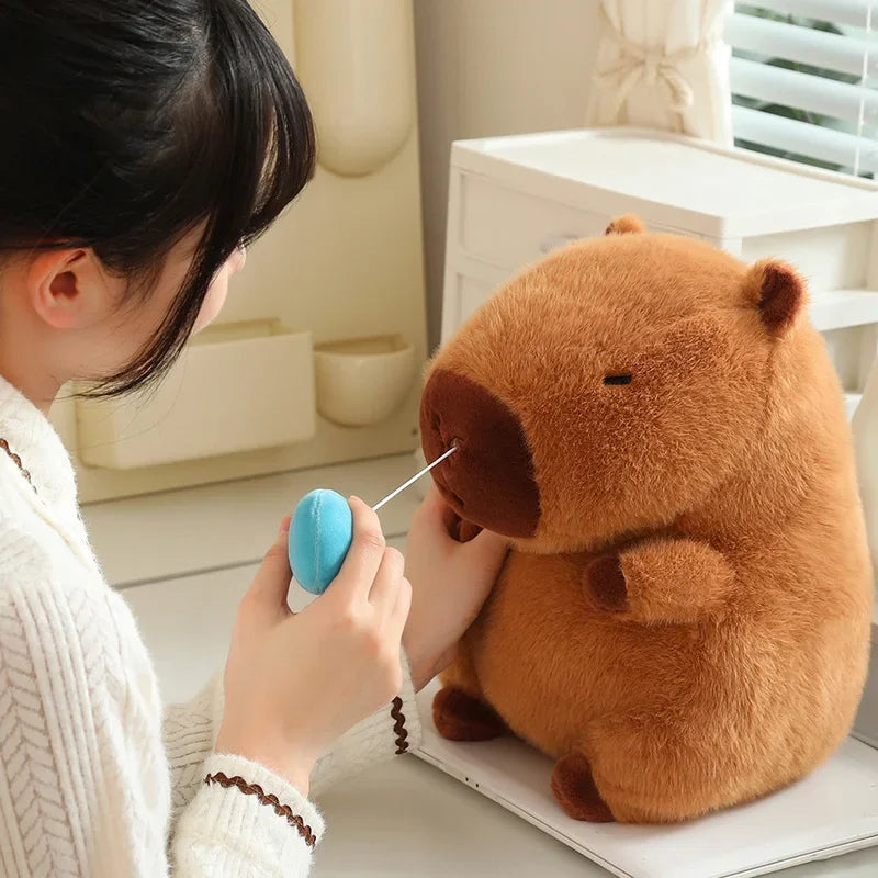 Person interacting with a kawaii plush bear toy using a blue object.