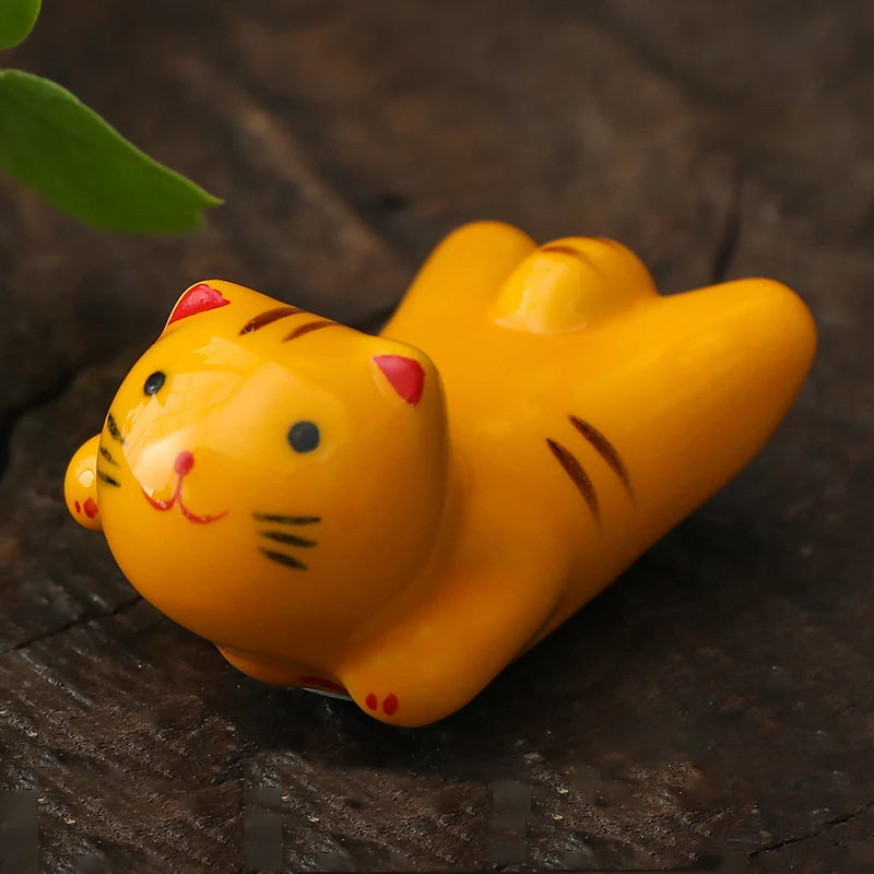 Yellow kawaii cat-shaped toy on a dark surface