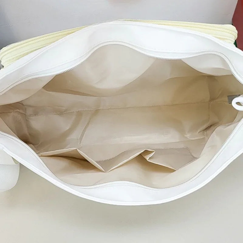 Close-up of a white Kawaii bag with a yellow interior lining on a light gray background