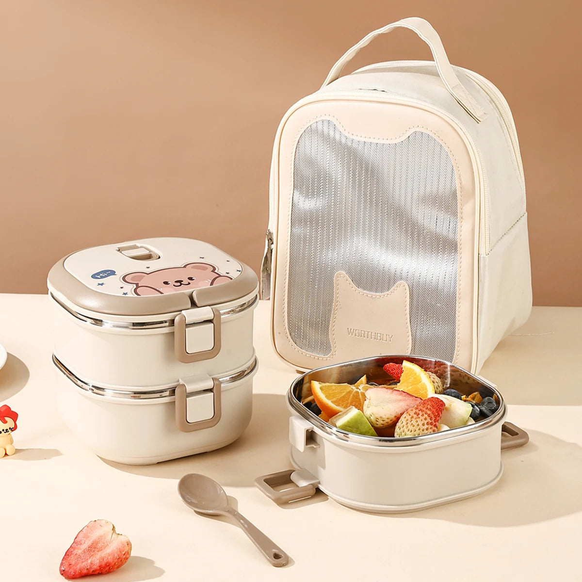Lunch box set with fruit salad, spoon, and kawaii bear-themed container on a beige background