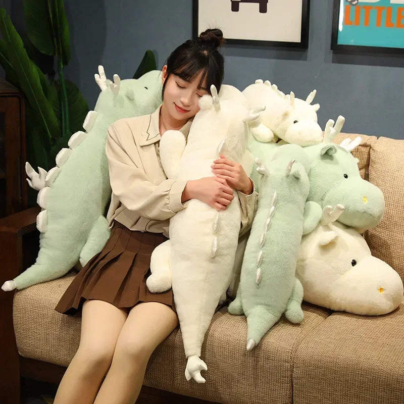 Woman sitting on a couch surrounded by kawaii plush dragon toys