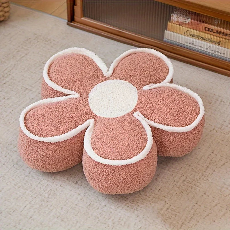 Flower-shaped pink kawaii cushion on a textured surface with a wooden frame in the background.