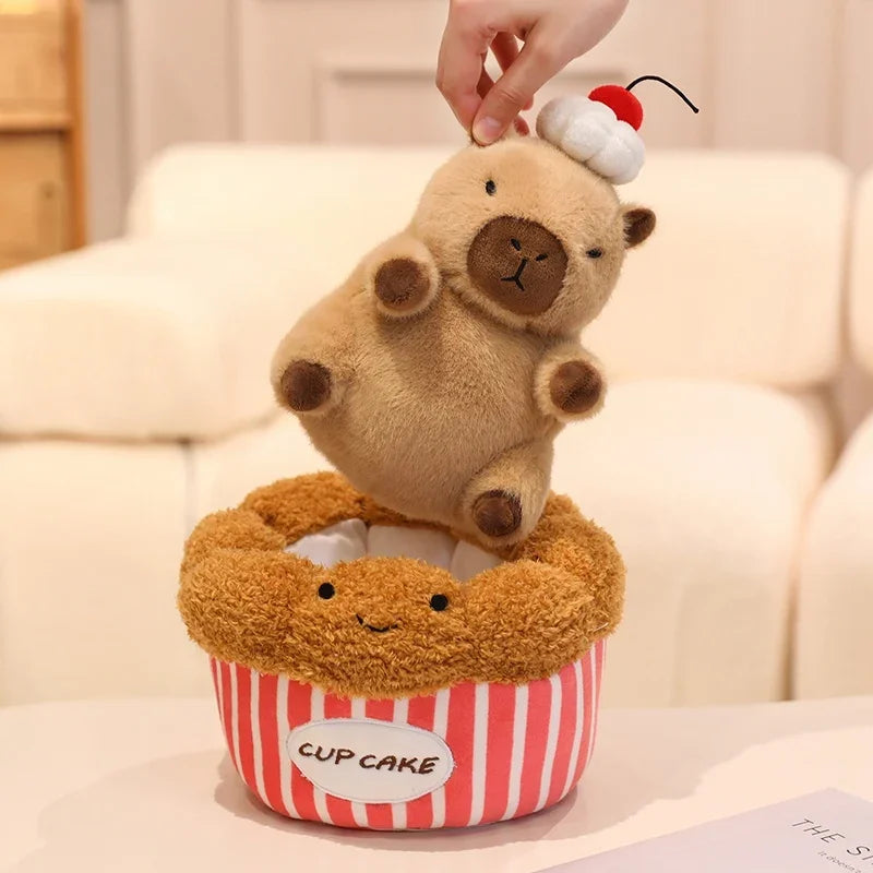 Kawaii plush toy bear in a cupcake container on a light-colored surface.