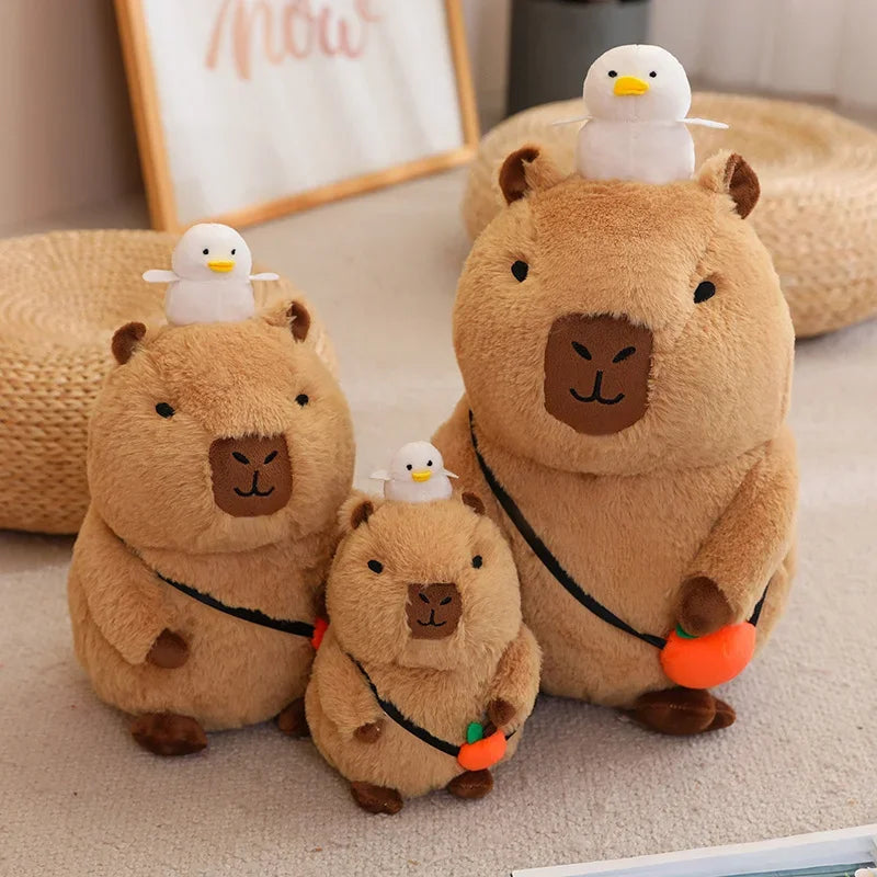 Three plush kawaii toys resembling beavers with small white birds on their backs, placed on a carpeted floor.