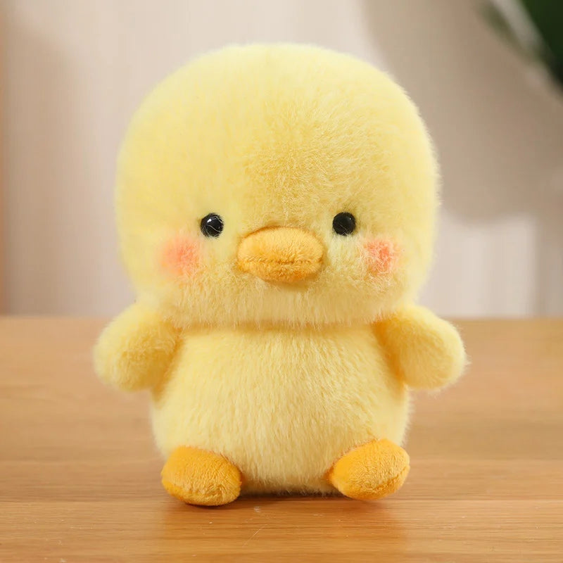 Yellow plush kawaii toy chick on a wooden surface with a blurred background