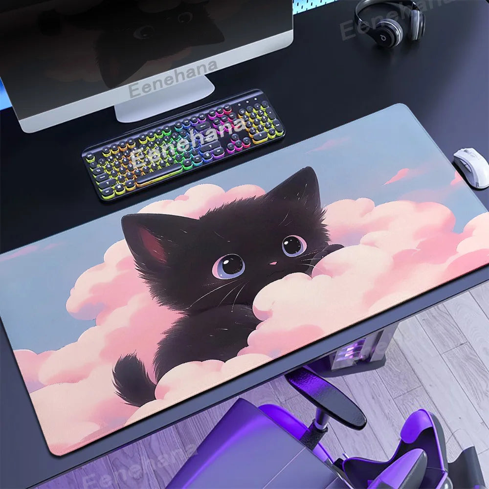 Desk setup with a large mouse pad featuring an illustration of a Kawaii black cat on clouds, keyboard, and monitor.